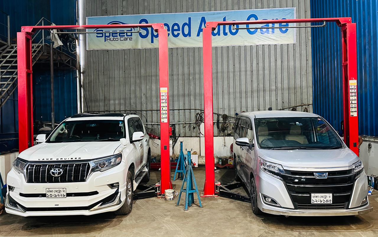 Vehicles undergoing seasonal checkup on the workshop lifters