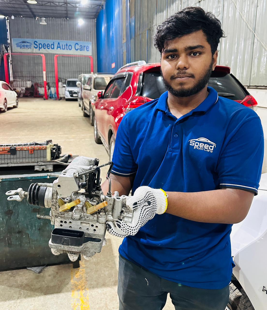 Electronic brake actuator assembly held by a Speed Auto Care technician