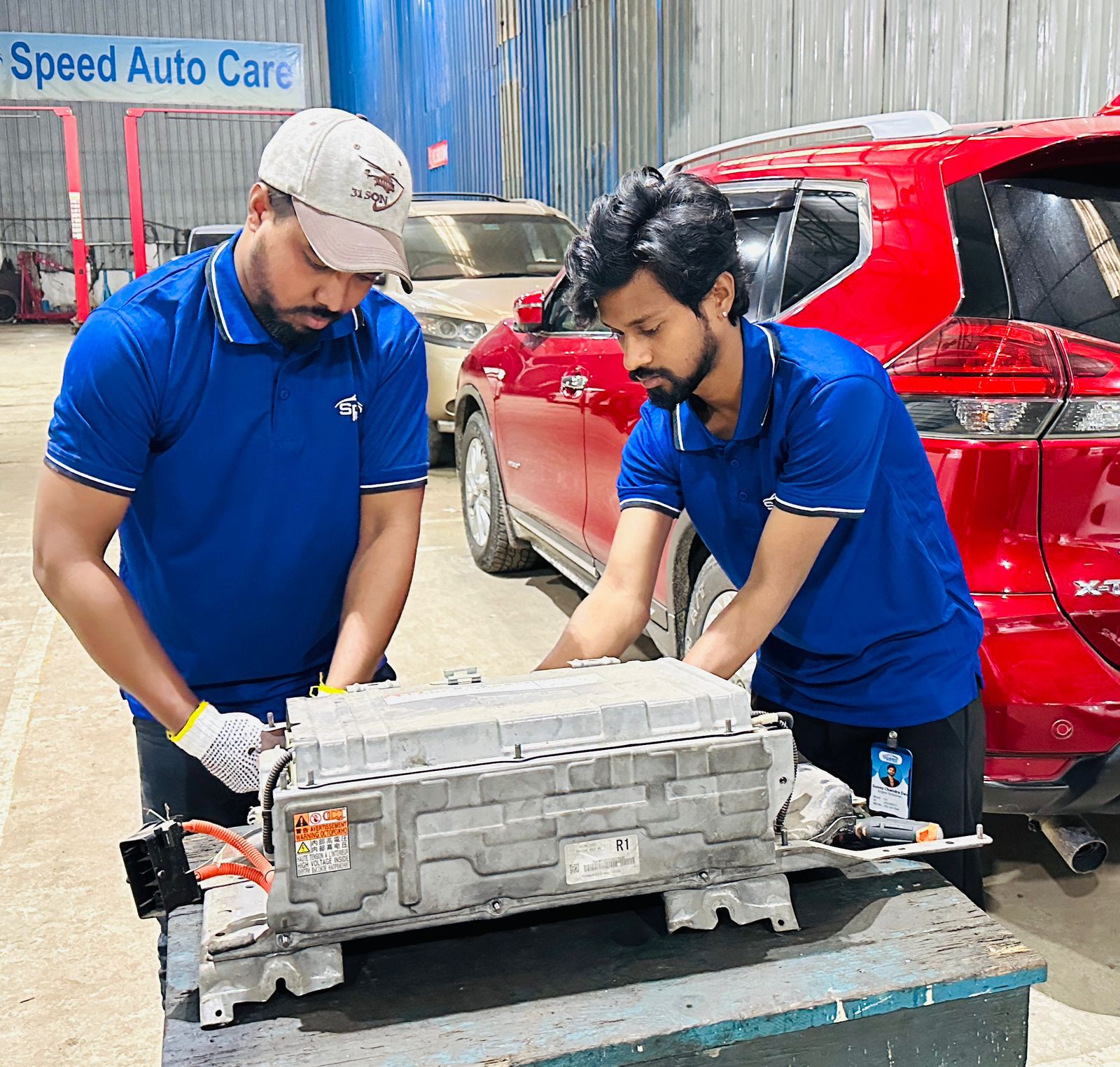 Speed Auto Care technicians servicing a hybrid battery pack