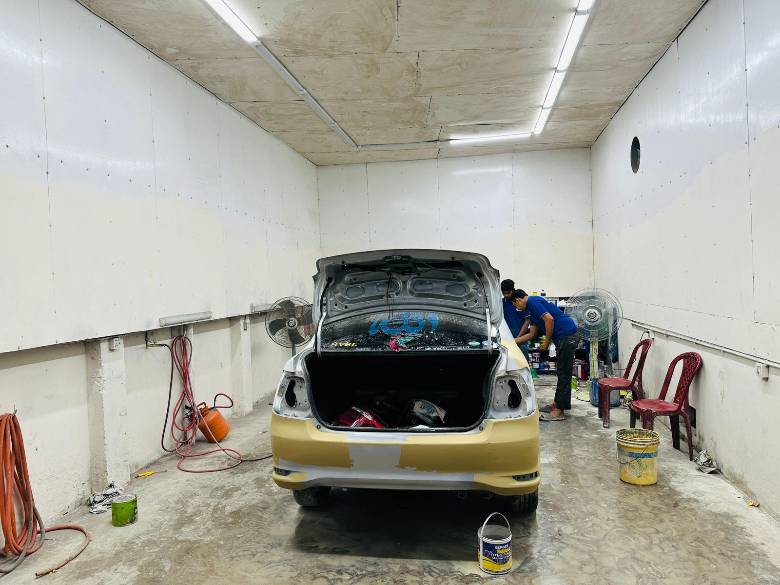Speed Auto Care paint booth with a vehicle being prepped