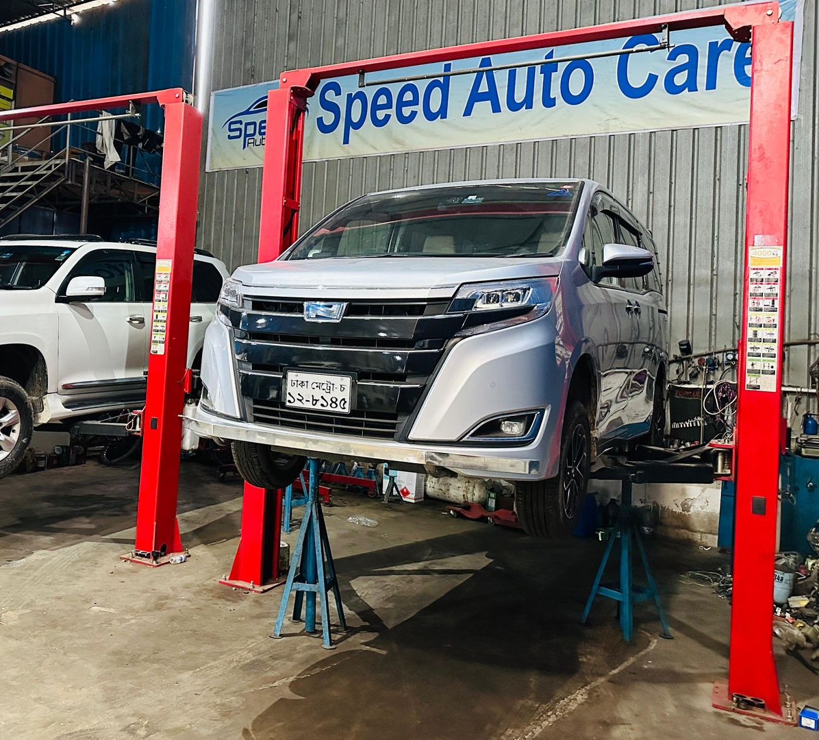 Vehicles on lifters at the Speed Auto Care workshop